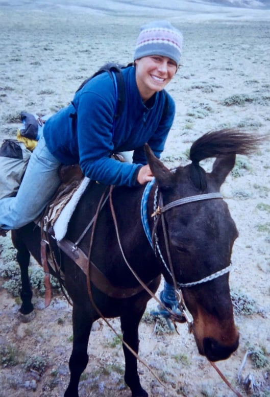 Erica smiles on horseback during the horsepacking section of her NOLS semester