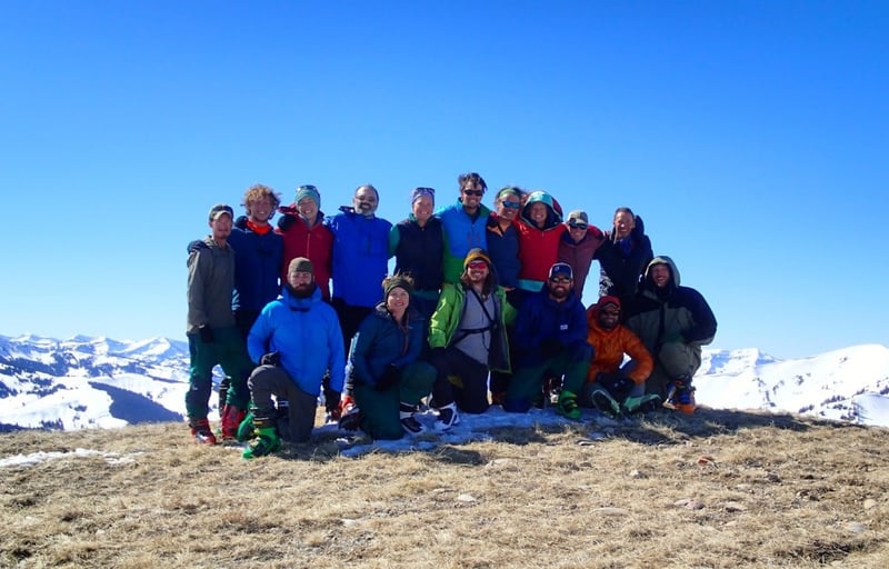 smiling NOLS semester students gather for a group photo in the Rocky Mountains