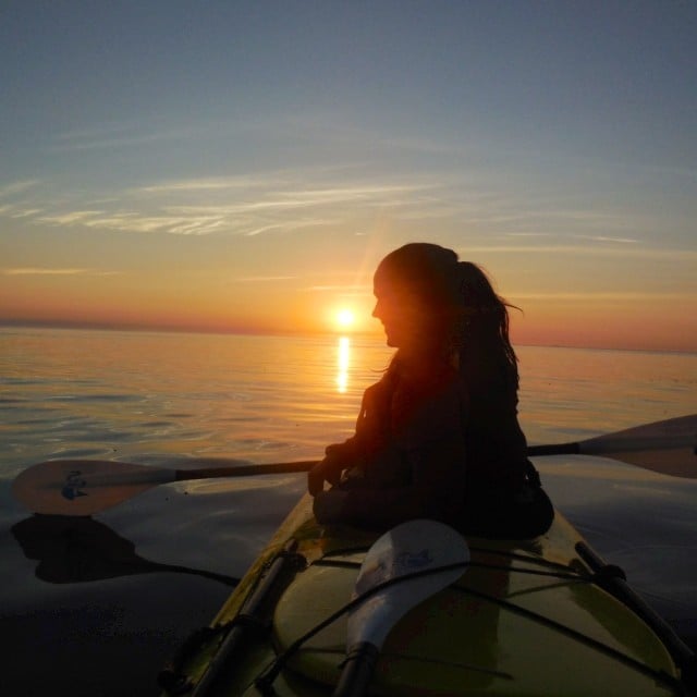Silhouette of a sea kayaker at sunset