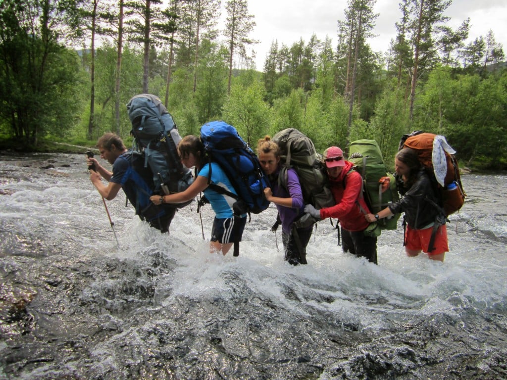 Group crossing a river in a line