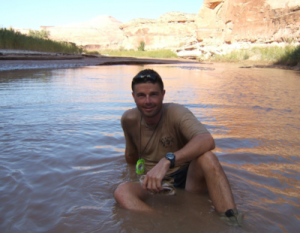 Reid bathes in the Dirty Devil River on a 2010 NOLS expedition in Utah's canyonlands.