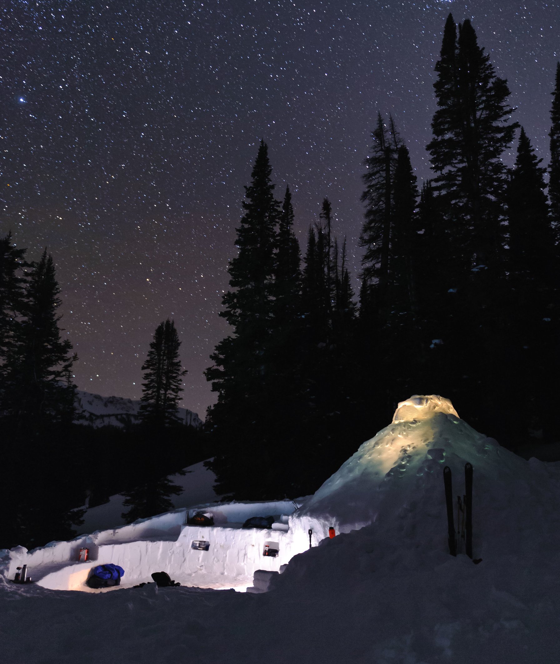 NOLS snowshelter and snow kitchen on a winter night in the Wyoming Range