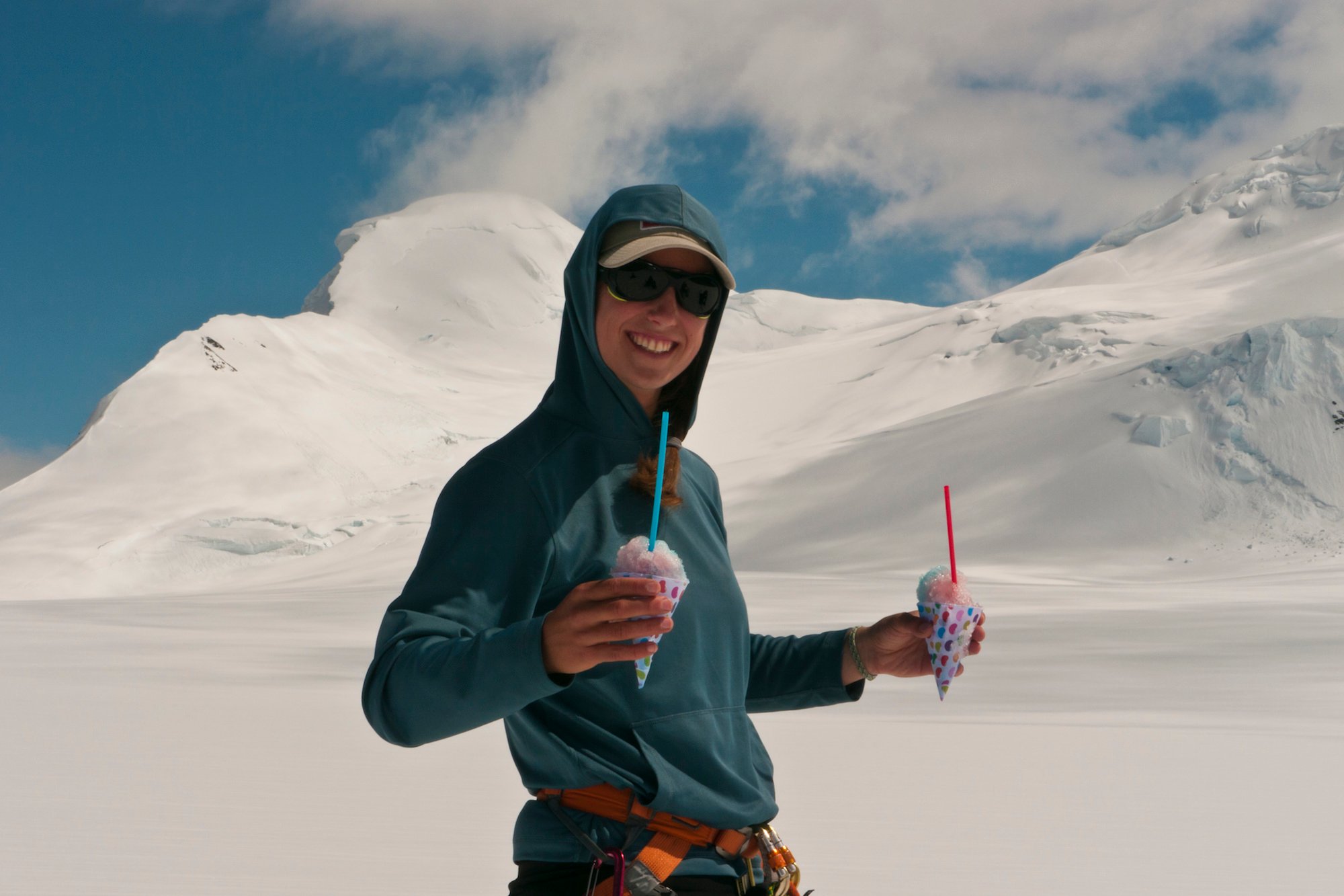 smiling NOLS instructor carries snowcones to her students on July 4th