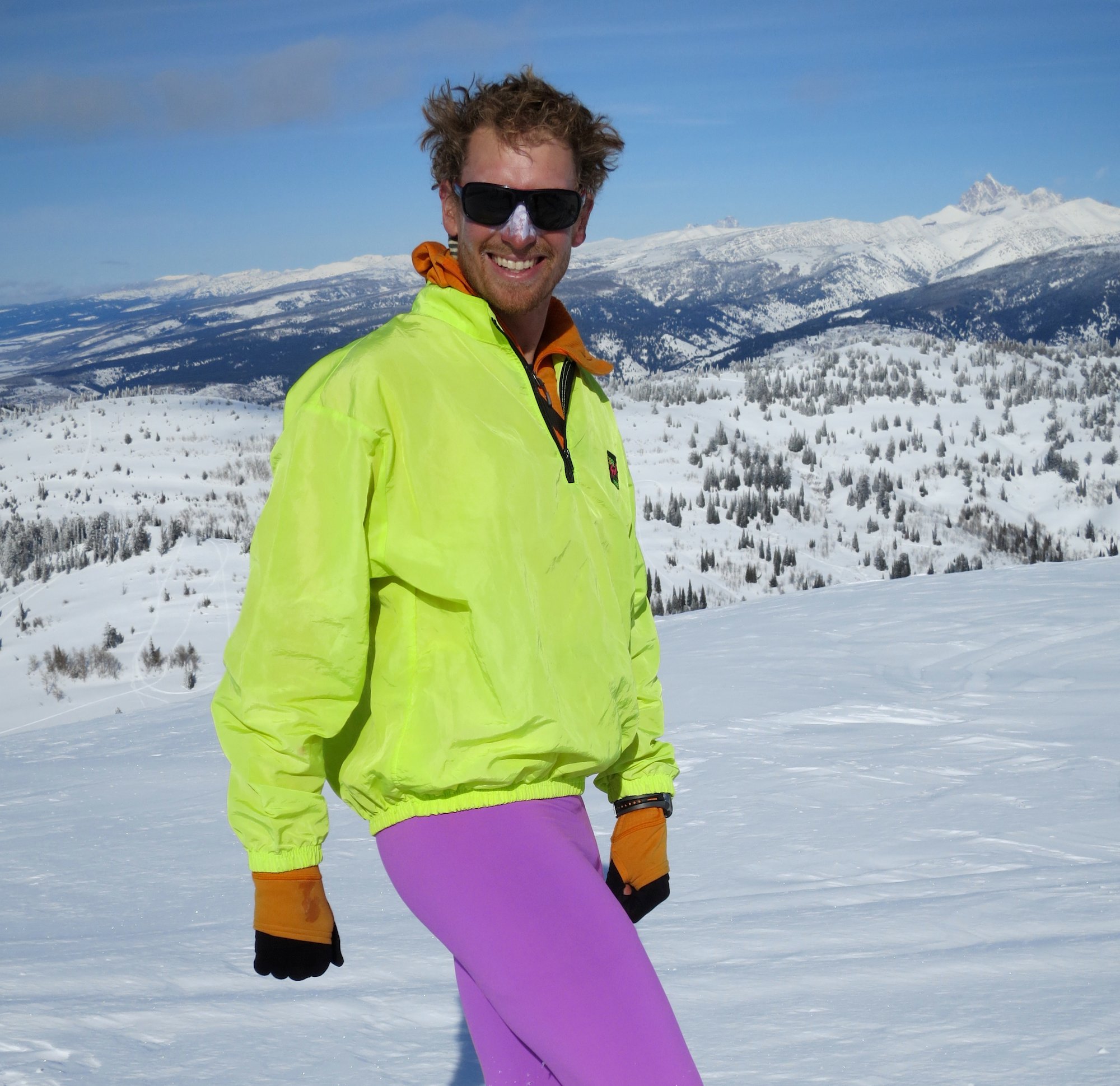 NOLS participant with fluorescent jacket and brightly colored tights models winter fashion