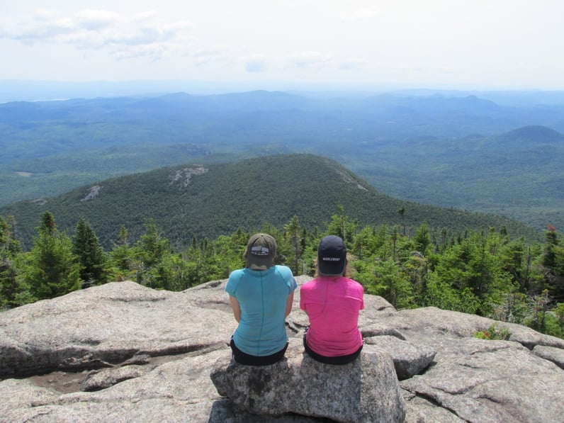 Two students take a break while backpacking in the Adirondacks