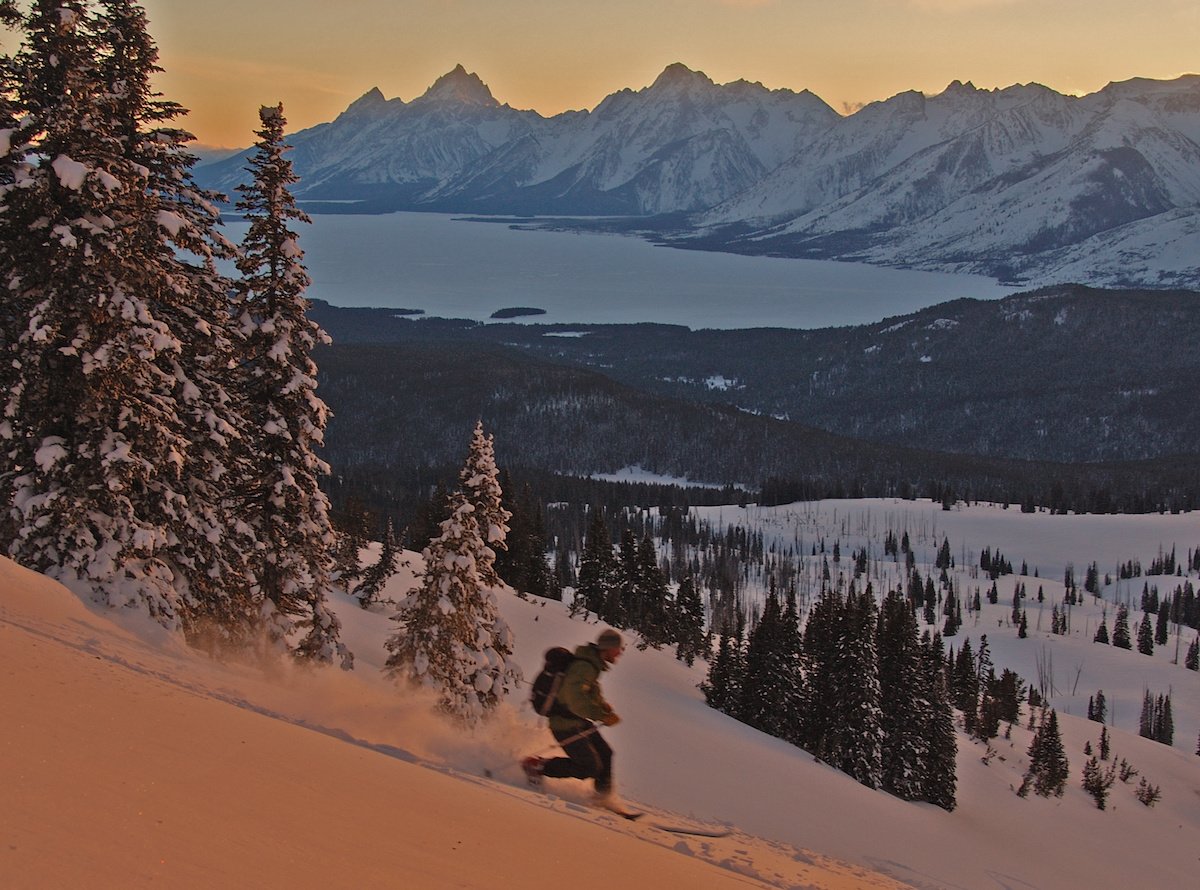 NOLS participant backcountry skis in the Tetons at sunset