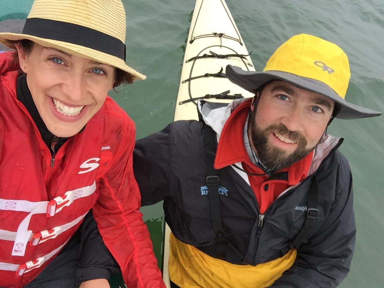 Yemaya and Lucas smile from a kayak