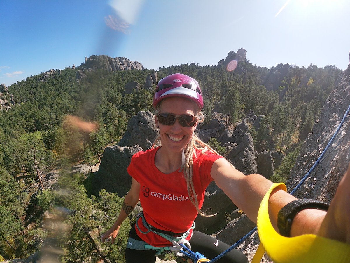 Eli takes a selfie during a climbing route