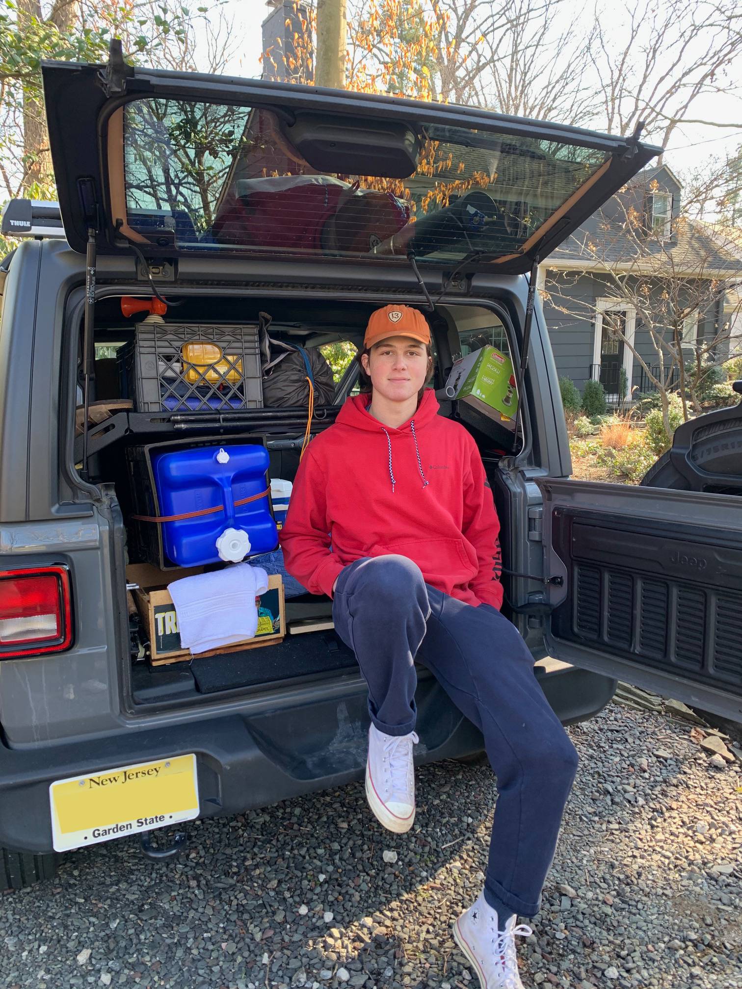 Tommy sits on the back of his van