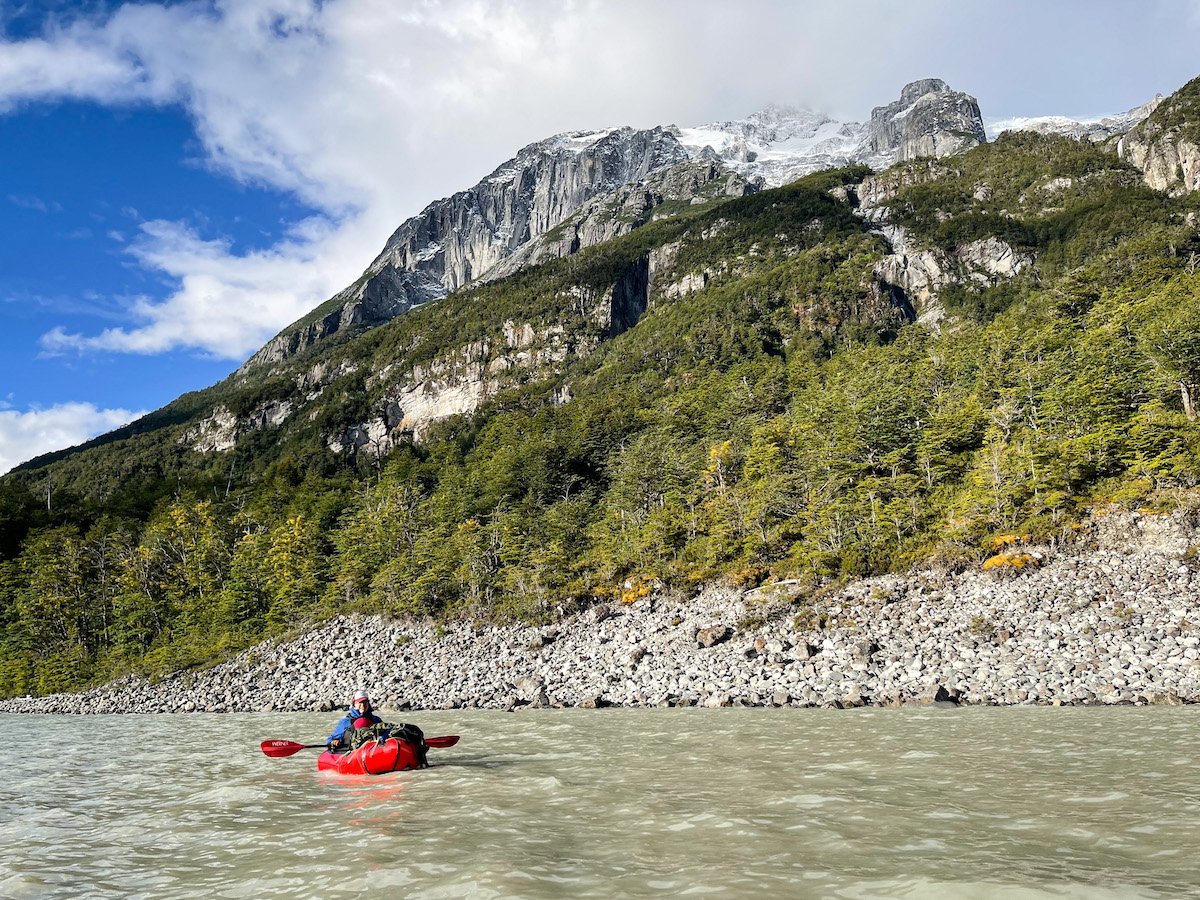 Woman packrafts on a wide river