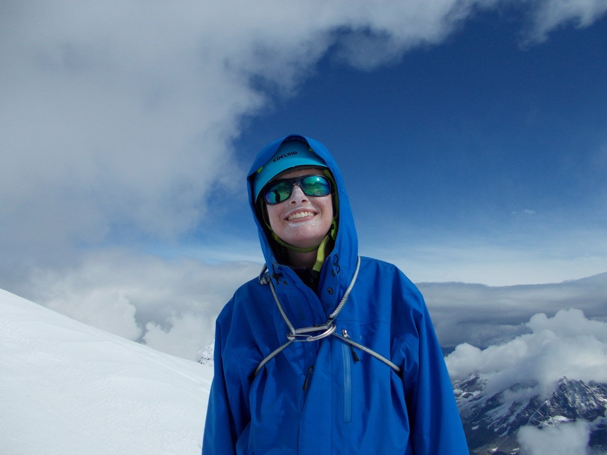 Author smiles wearing a mountaineering helmet