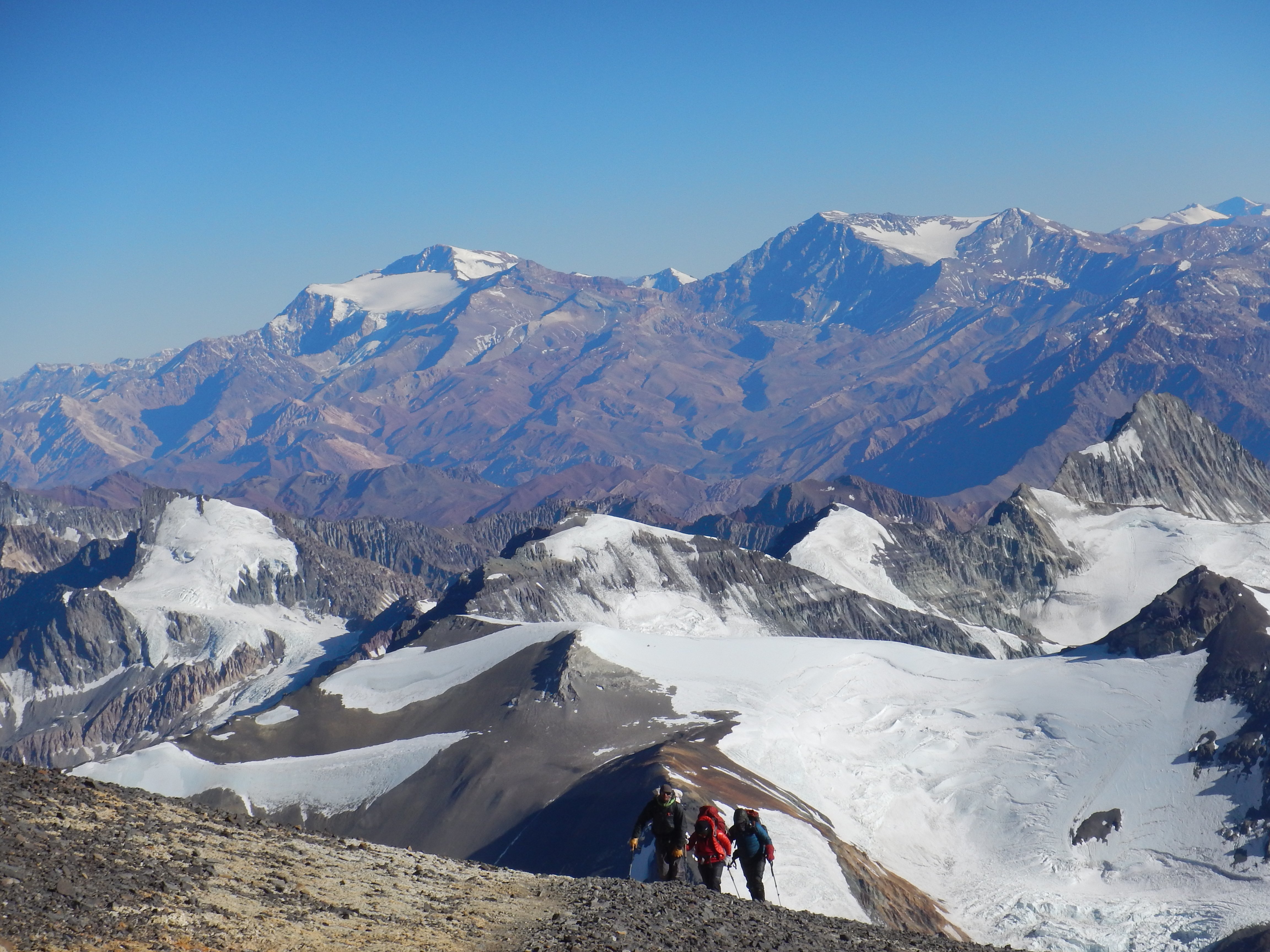 Three climbers making their way up a ridge on the way to the summit of Aconcagua