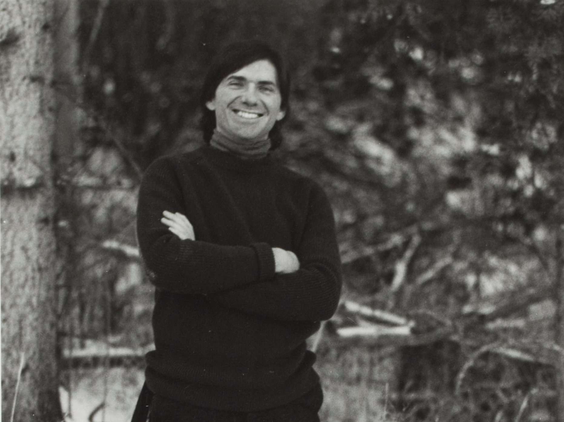 Peter Simer, smiling with his arms crossed