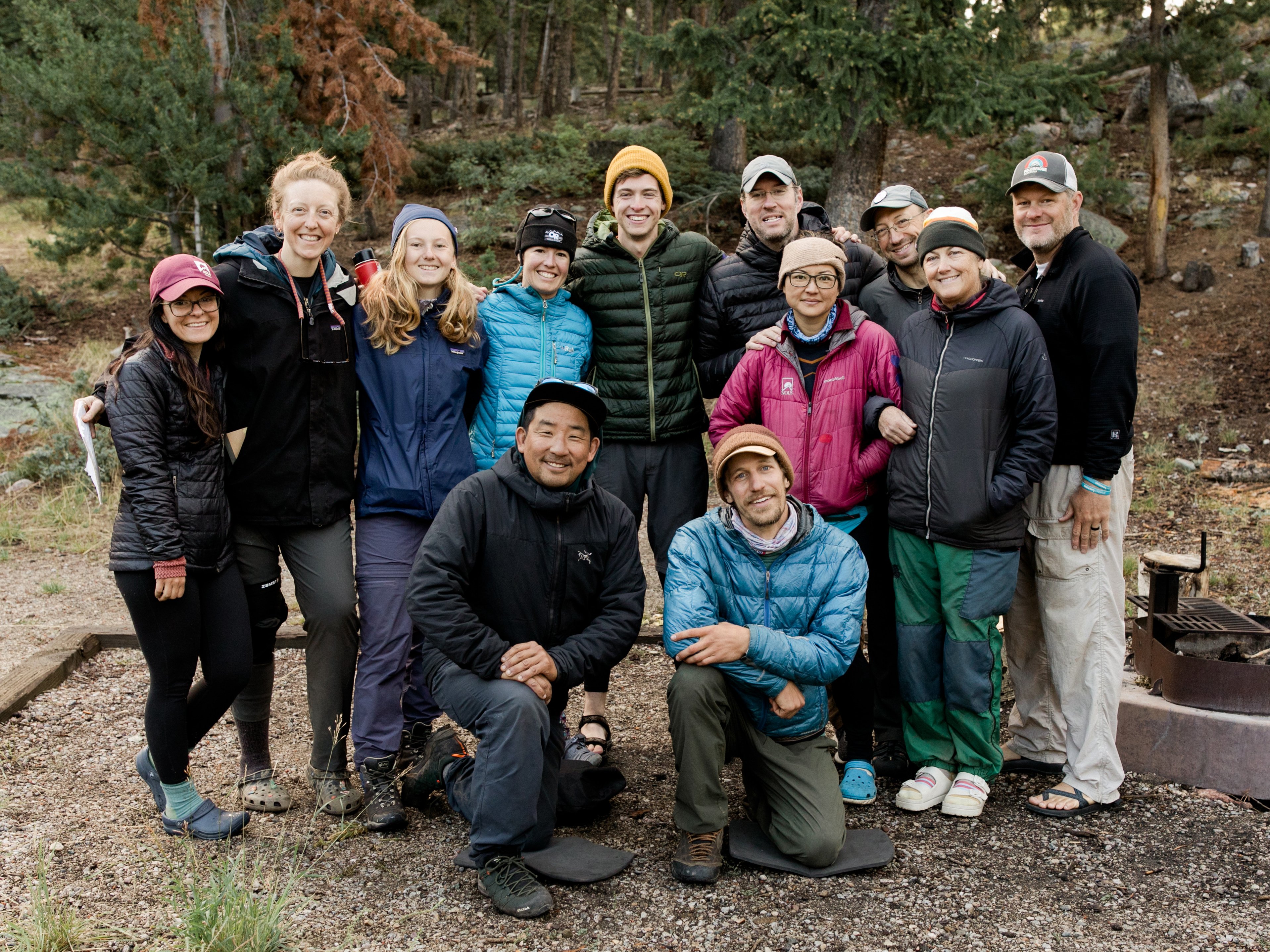 Group of NOLS students and instructors gathered in two rows for a photo.