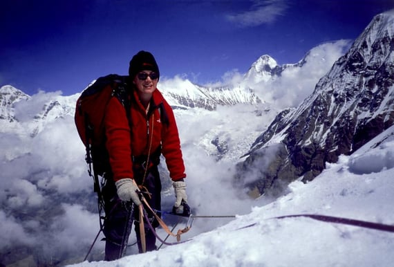A woman pauses while mountaineering in India