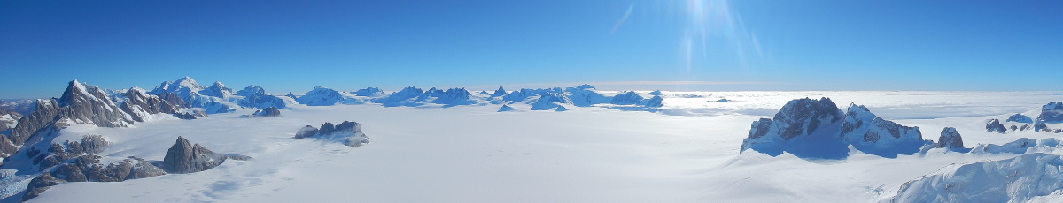 a sweeping view of snow and icy peaks on a sunny day in Patagonia