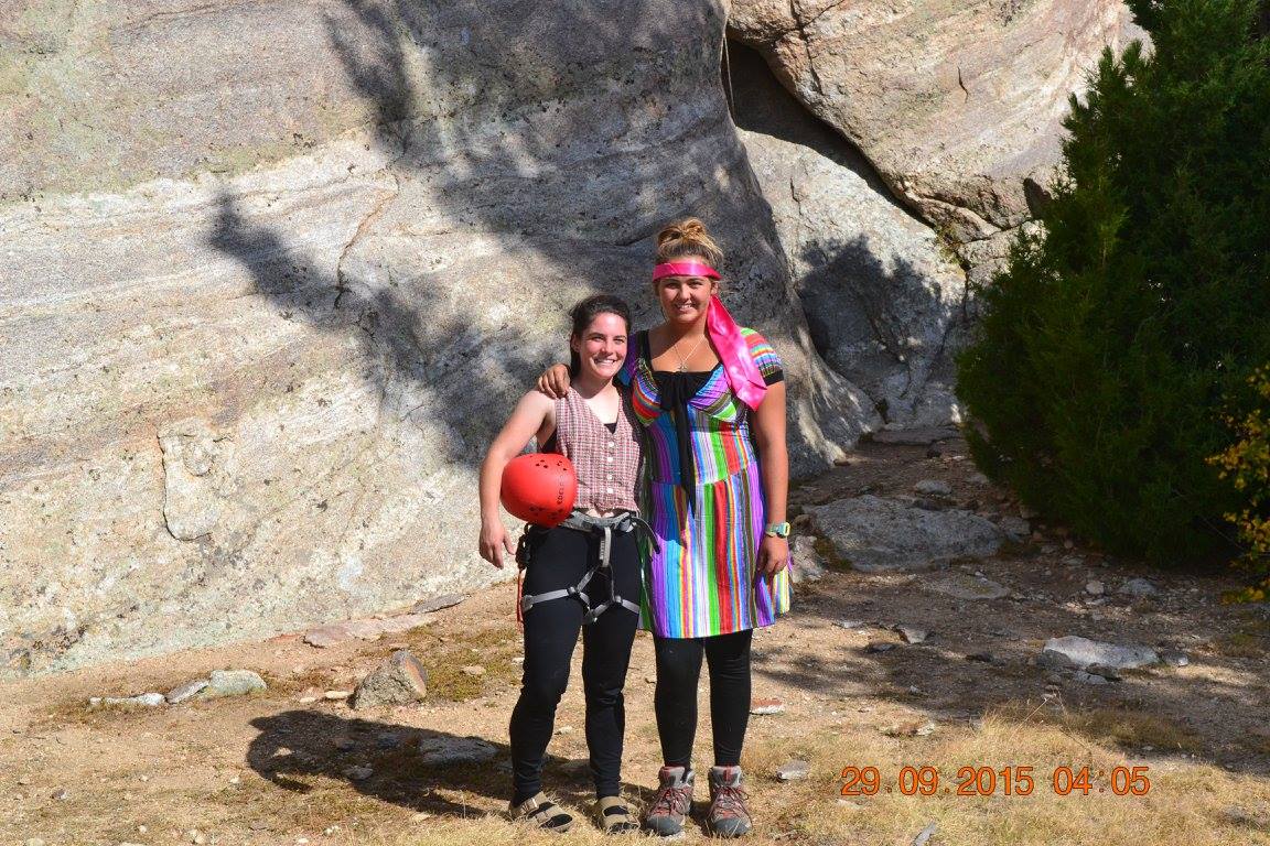 Two climbers in costumes smile