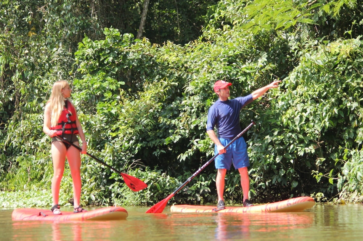 Father and daughter on stand-up paddleboards