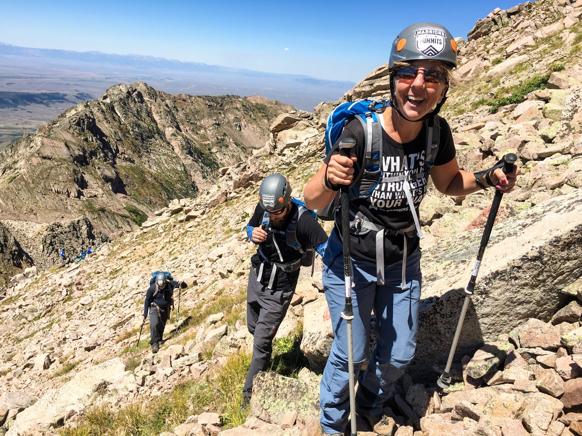 Participants backpack up a ridgeline