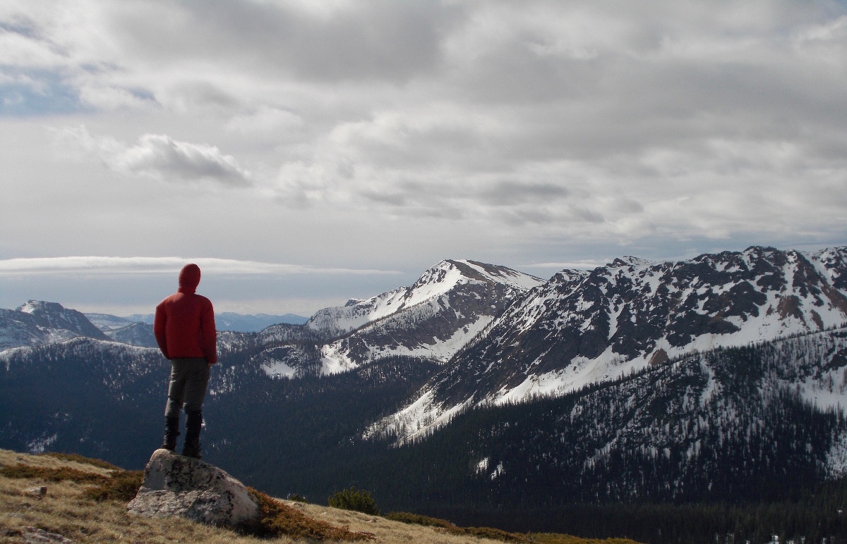 Person looks over a mountain landscape