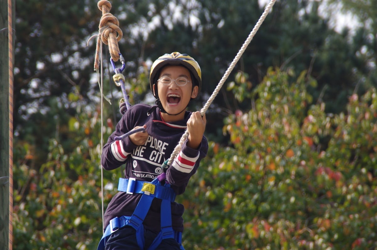 KIS student having fun on a ropes course