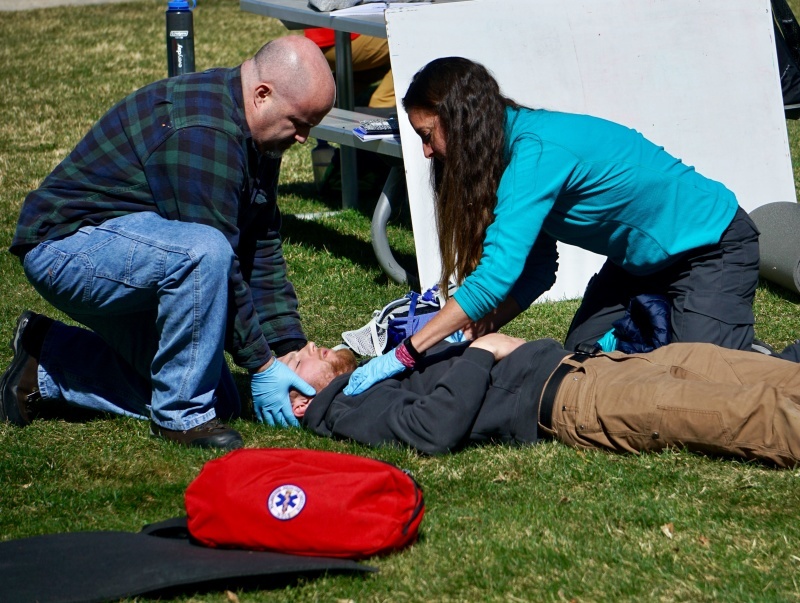 Practicing a patient assessment in a mock scenario for wilderness first aid