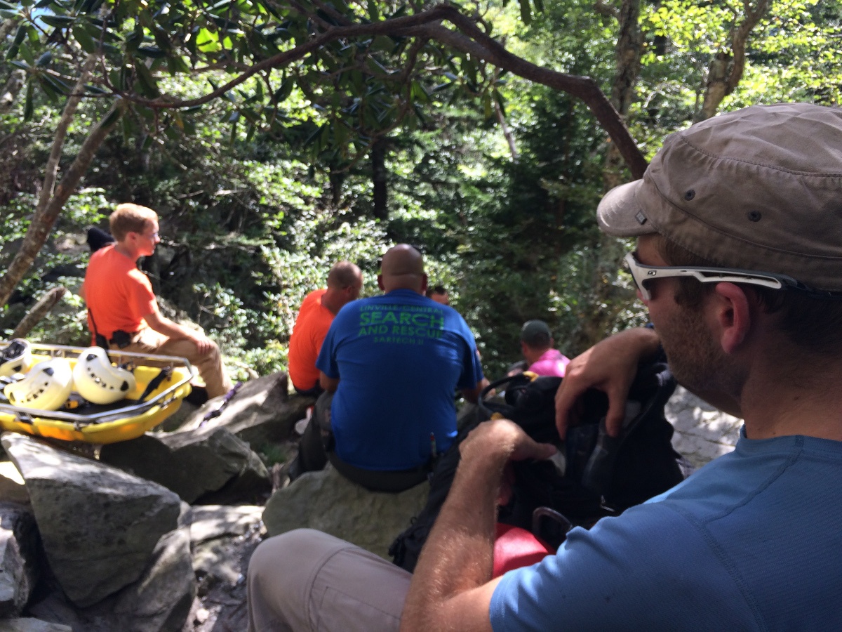 Search and Rescue members work together to help care for a patient outdoors