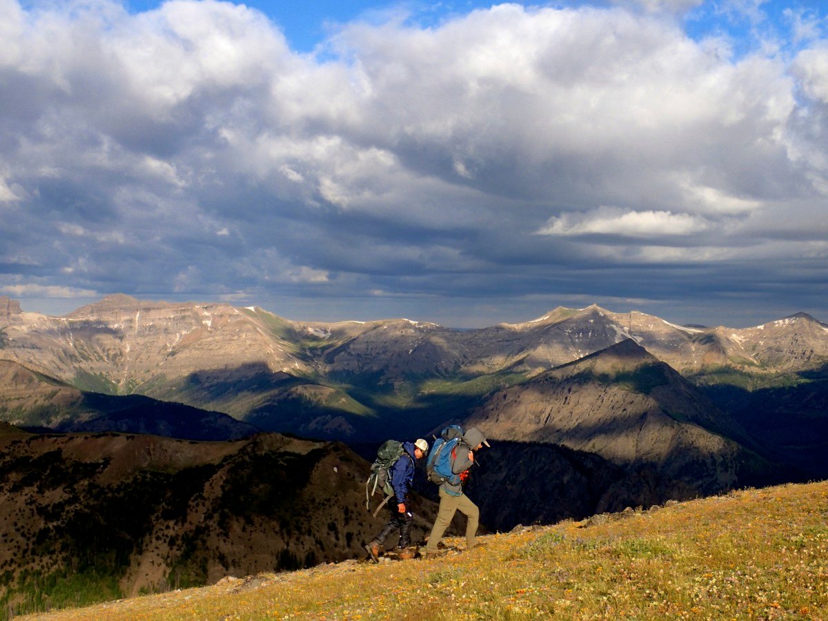 HIking in the mountains with clouds on the horizon