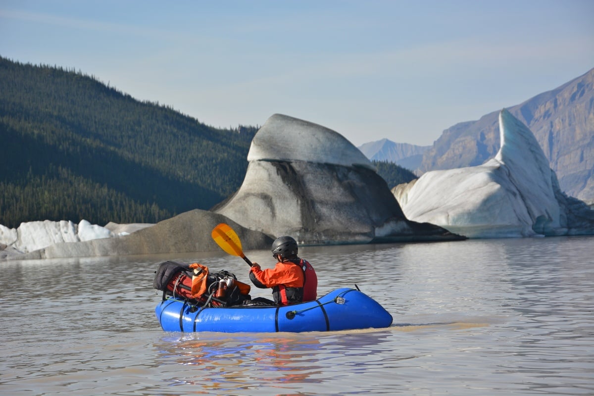 A student paddling with icebergs on the Nizina River