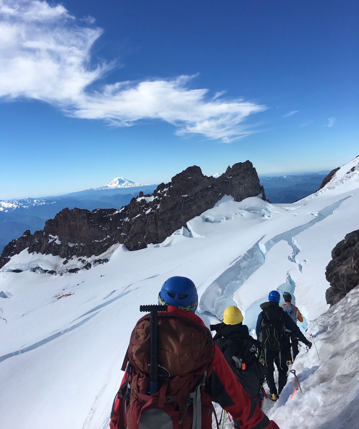 A rope team treks through the snow on Mt. Rainier