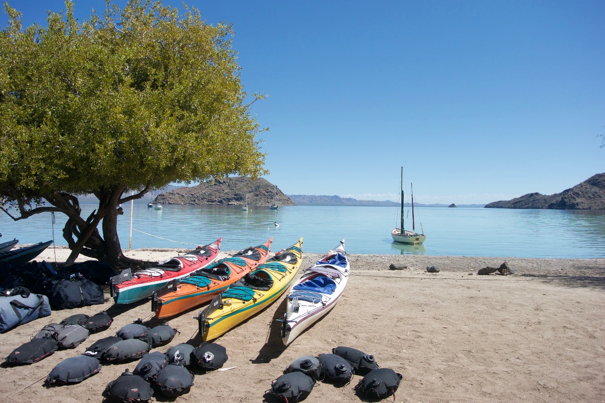 Boats on the shore with full water bags at the beginning of the trip