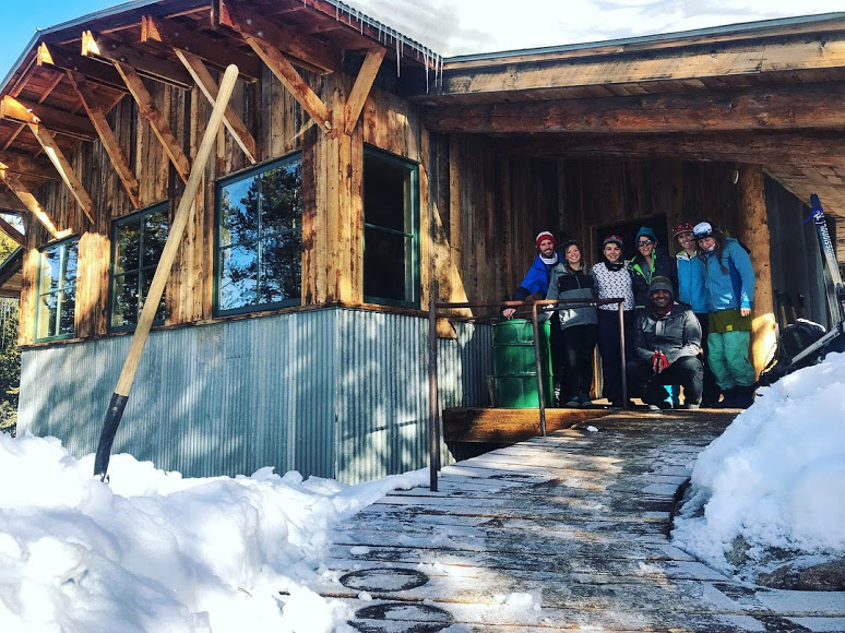 A group smiles in a mountain lodge