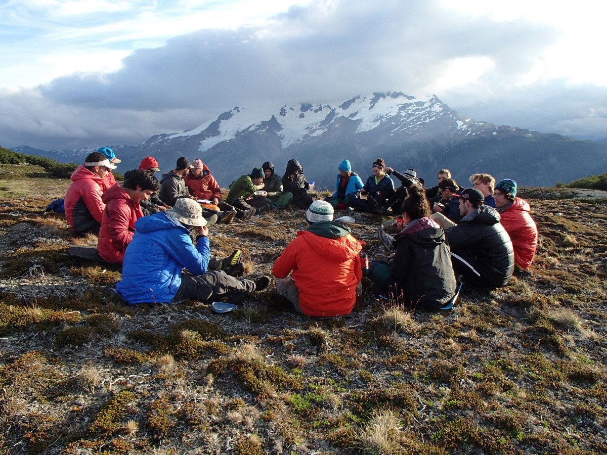 Group of NOLS students have a discussion sitting in a circle