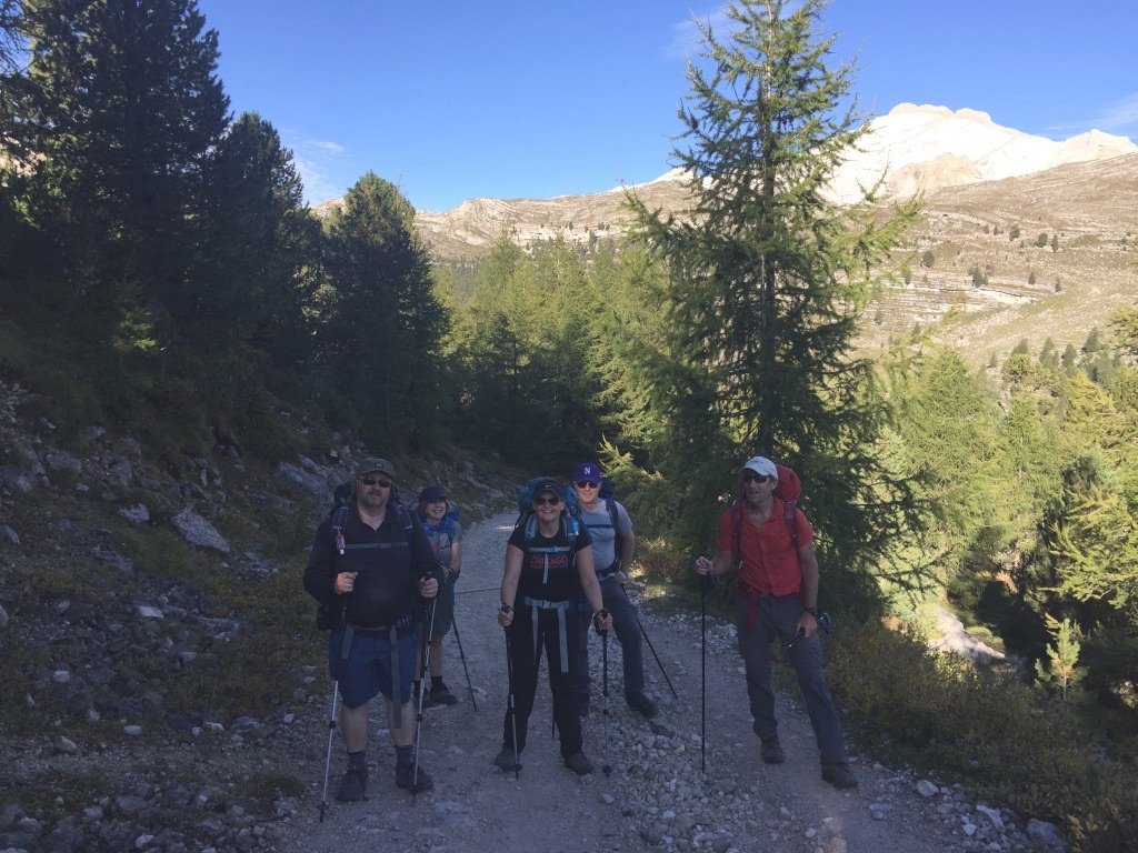 Group photo of hikers smiling on trail