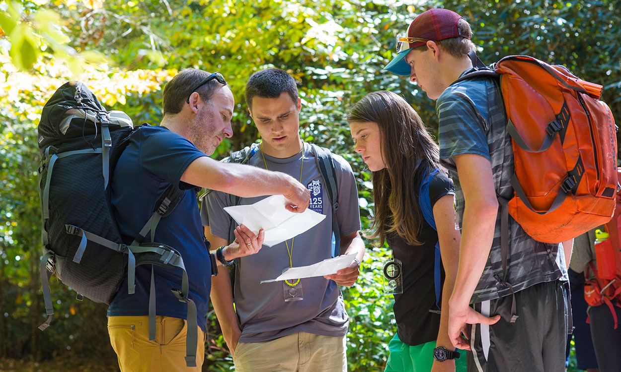 Andrew Bobilya teaches navigation skills on a hike with students