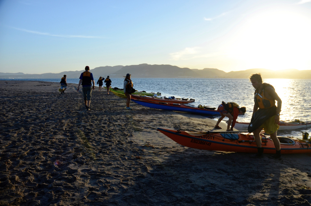 Sea kayaks resting on shore