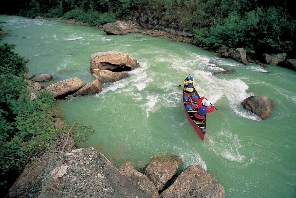 NOLS students paddle a whitewater canoe in the Yukon, as seen from above