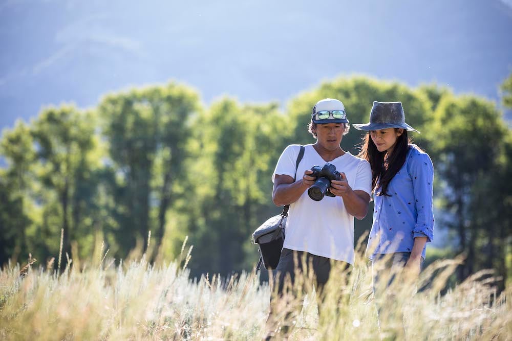 Jimmy Chin and E. Chai Vasarhelyi look at the latest shots on a camera in the field