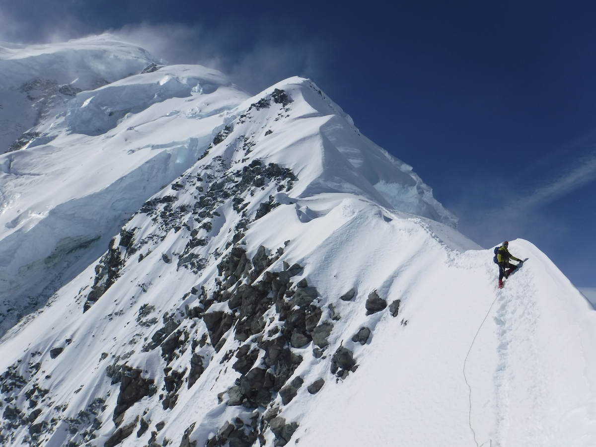 Mountaineering on a snowy slope on Mount Logan on a sunny day