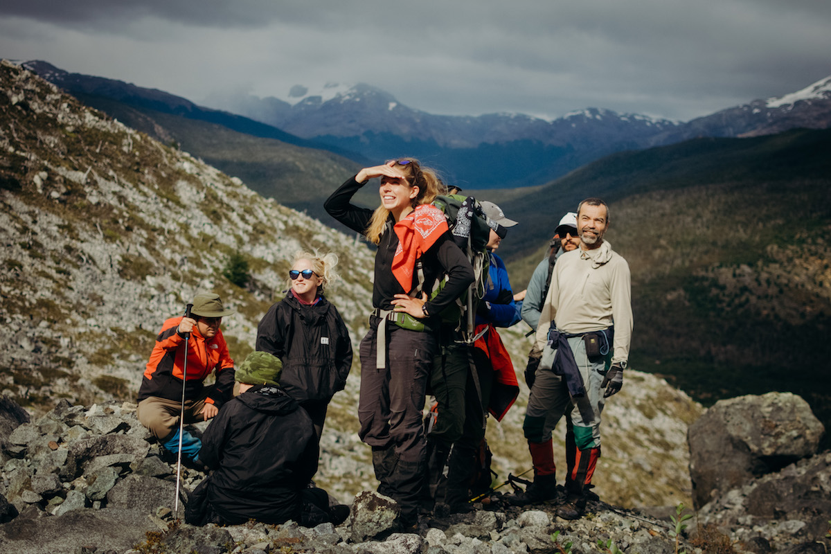 A group of NOLS students pauses while hiking