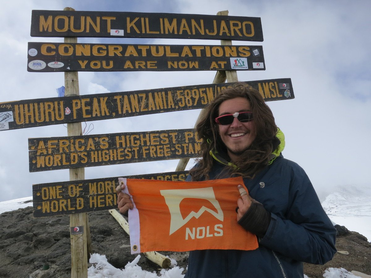 Steve on the summit of Kilimanjaro with a NOLS summit flag