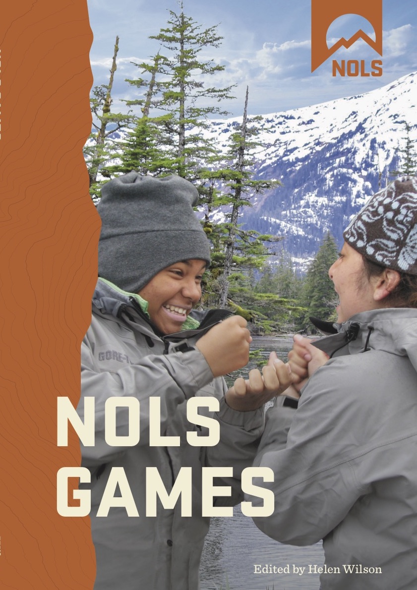 cover of NOLS games book smiling students playing game in the mountains