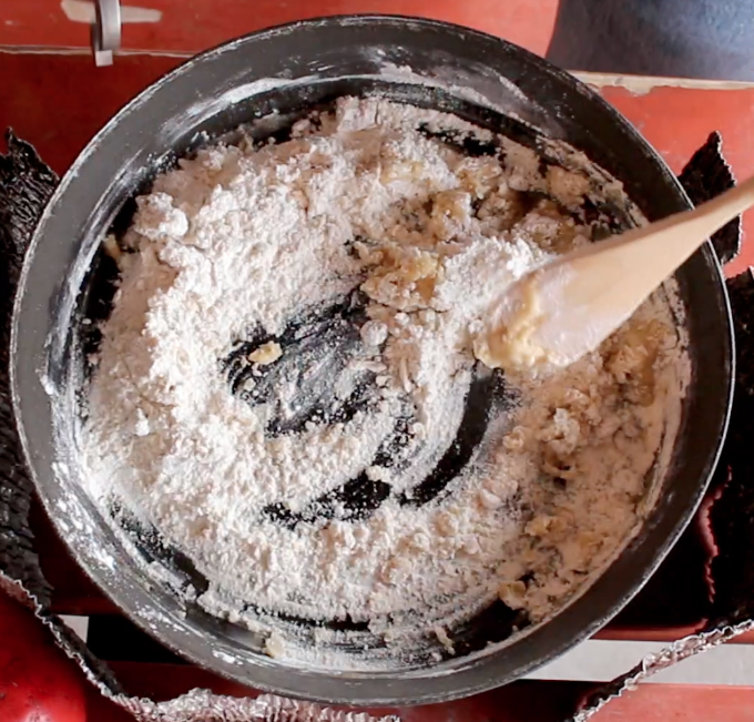 wooden spoon stirs pie crust ingredients in a frying pan