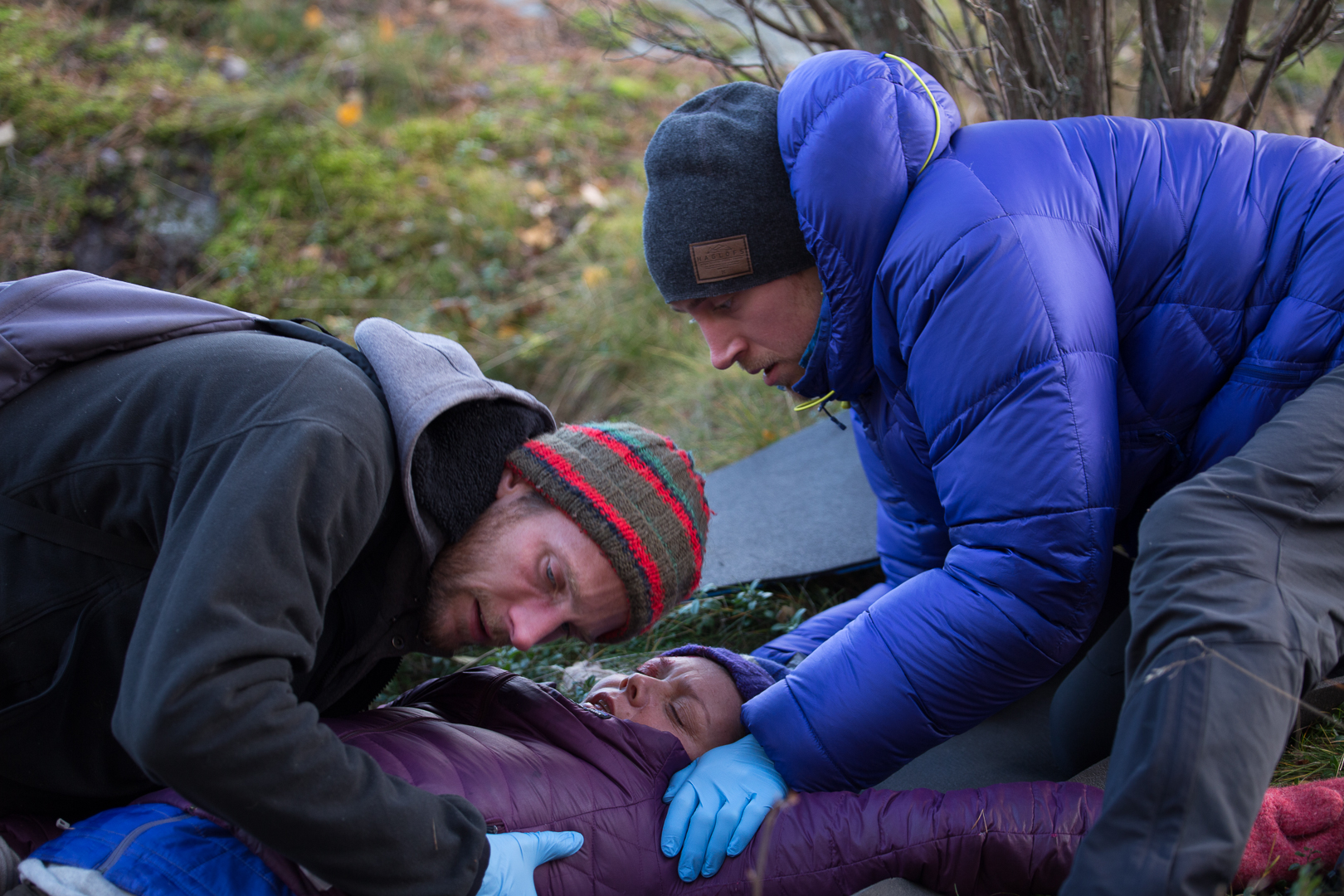 Two rescuers conduct a patient assessment on an unconscious patient