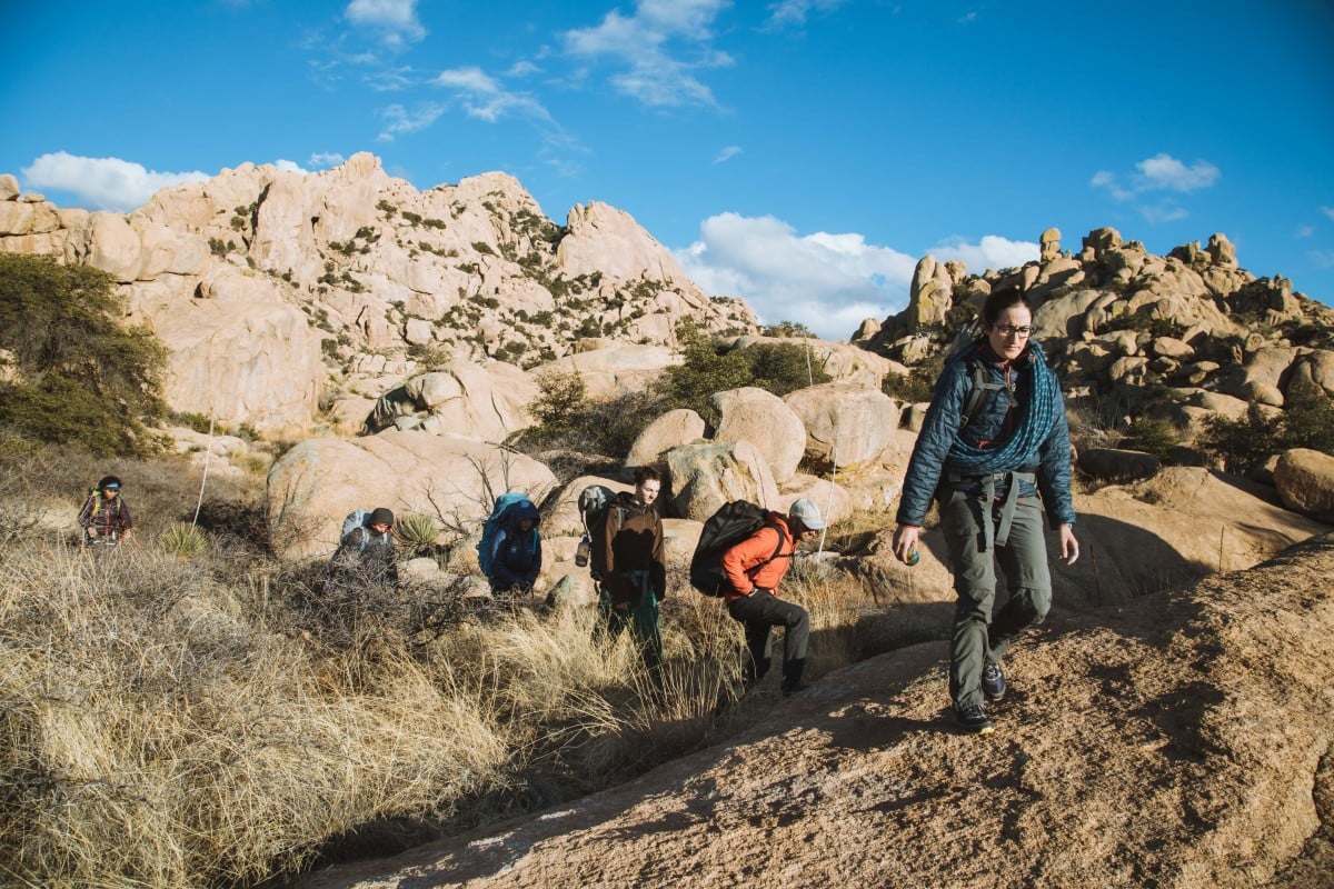 Group of hikers with rock climbing gear in rocky landscap