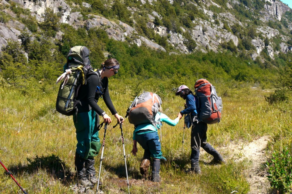 Helping a friend out of the mud while hiking