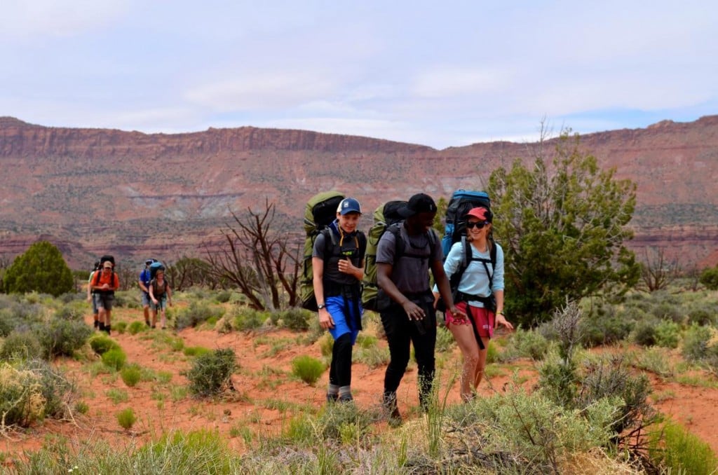 People hiking happily in the desert