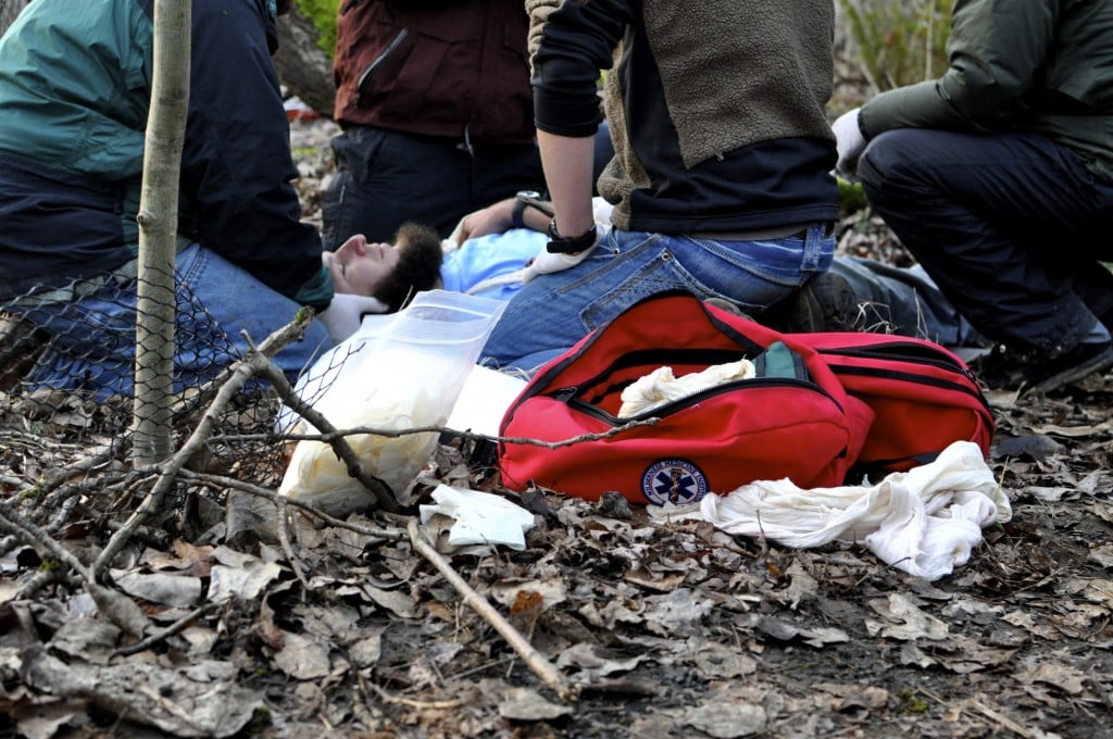 First aid supplies on the ground as students practice giving first aid