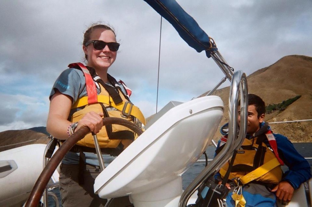 Molly Hunt at the helm of a sailboat