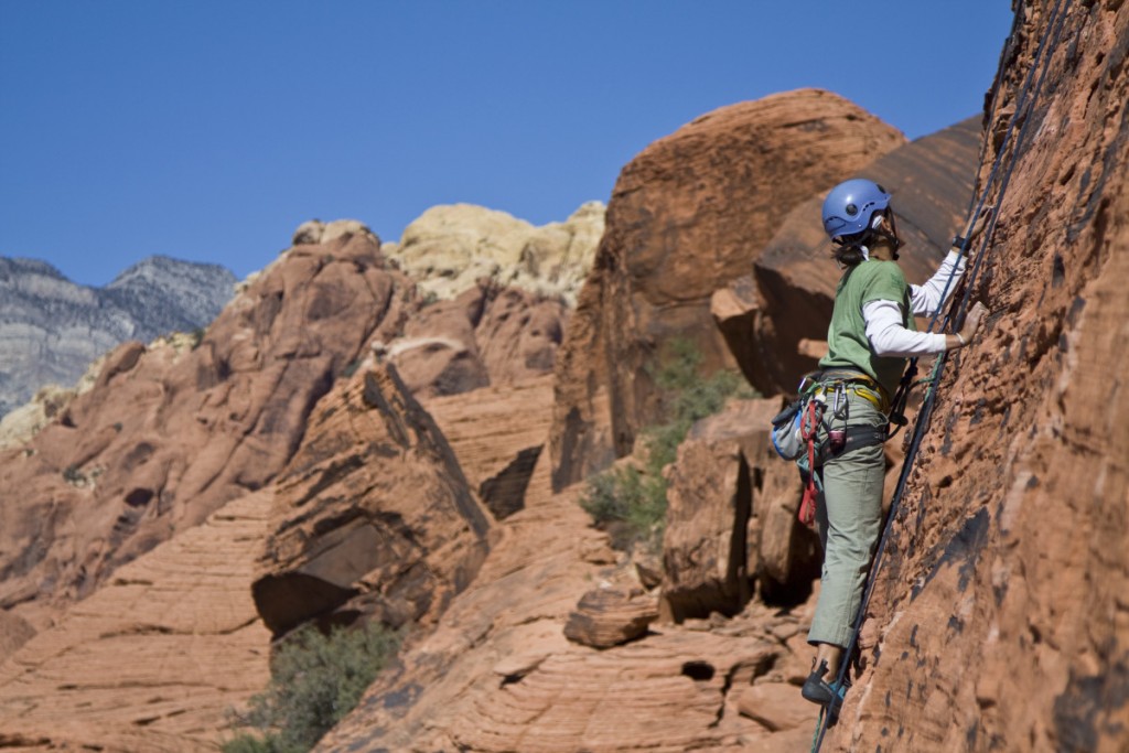 Rock climber scales a sandstone wall